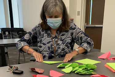 Picture of Amy Armstrong cutting paper hearts